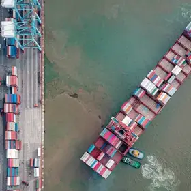 top aerial view of the containers ships sailing cross over each other in the sea, carriage the shipment from loading port to destination discharging port, transport and logistic service to worldwide